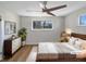 Cozy bedroom with a large window, ceiling fan, and comfortable furnishings at 6650 Depew Ct, Arvada, CO 80003