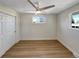 Comfortable bedroom with neutral walls, wood flooring, a ceiling fan, and a window view at 6650 Depew Ct, Arvada, CO 80003