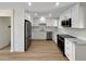Modern kitchen with white cabinets, stainless steel appliances, and ample counter space at 6650 Depew Ct, Arvada, CO 80003