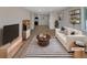 Bright living room featuring stylish decor, a modern rug, and an open layout at 6650 Depew Ct, Arvada, CO 80003