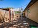 A charming backyard featuring a gravel area with pavers and a white pergola at 6943 Oak Way, Arvada, CO 80004