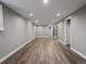 Finished basement space with neutral walls, recessed lighting and modern wood-look flooring at 6943 Oak Way, Arvada, CO 80004