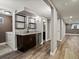 Finished basement features a wet bar, wine fridge, and modern finishes with access to laundry room at 6943 Oak Way, Arvada, CO 80004