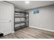 Basement storage room with metal shelving and vinyl flooring at 6943 Oak Way, Arvada, CO 80004