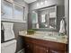 Bathroom features a stylish granite countertop, wood cabinets, and neutral gray wall color at 6943 Oak Way, Arvada, CO 80004