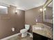 Bathroom featuring granite countertop, tile floors, modern toilet and large mirror at 6943 Oak Way, Arvada, CO 80004