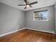 Inviting bedroom with hardwood floors, neutral walls, ceiling fan, and bright natural light at 6943 Oak Way, Arvada, CO 80004