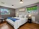 Cozy bedroom with a plush bed, stylish headboard, and ample natural light from two windows at 6943 Oak Way, Arvada, CO 80004
