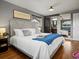Comfortable bedroom boasts a luxurious bed, mirrored closet doors, and en-suite bathroom access at 6943 Oak Way, Arvada, CO 80004