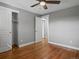 Clean bedroom features hardwood floors, ceiling fan, and closet with sliding doors at 6943 Oak Way, Arvada, CO 80004