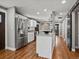 Kitchen with stainless steel appliances, white cabinets, granite countertops and wood floors at 6943 Oak Way, Arvada, CO 80004