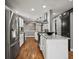 Modern kitchen featuring stainless steel appliances, granite countertops, and a breakfast bar at 6943 Oak Way, Arvada, CO 80004