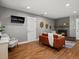 Comfortable living room with fireplace, hardwood floors, an orange sofa, and an accent chair at 6943 Oak Way, Arvada, CO 80004