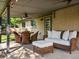 Covered patio with comfortable seating, wicker furniture, ceiling fans, and outdoor lighting at 6943 Oak Way, Arvada, CO 80004