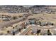 An aerial view displays a well-planned suburban neighborhood nestled in a scenic open space at 1022 Orion Way, Castle Rock, CO 80108