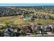 An inviting aerial view of a community pool with multiple homes and neighborhood landscaping in the background at 1022 Orion Way, Castle Rock, CO 80108