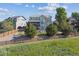 A spacious backyard features a wooden fence, mature trees, and a private setting at 1022 Orion Way, Castle Rock, CO 80108