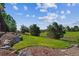 A serene backyard featuring lush greenery, mature trees, and privacy at 1022 Orion Way, Castle Rock, CO 80108