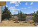 Beautiful backyard featuring mature trees, a firepit, and gravel at 1022 Orion Way, Castle Rock, CO 80108