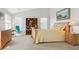 Bright bedroom with a beachy feel, featuring a king bed, bookshelf, and light neutral tones at 1022 Orion Way, Castle Rock, CO 80108