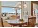 Bright breakfast nook with a round table and views of the backyard through large windows at 1022 Orion Way, Castle Rock, CO 80108