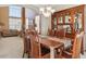 Dining room features a wooden table with 6 chairs, a glass display cabinet and large bright windows at 1022 Orion Way, Castle Rock, CO 80108