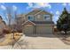 Charming two-story home features a brick-accented three-car garage and manicured landscaping at 1022 Orion Way, Castle Rock, CO 80108