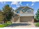 Two-story home with a three-car garage, brick accents, neutral siding, and a well-manicured lawn at 1022 Orion Way, Castle Rock, CO 80108