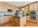 Bright kitchen with stainless steel appliances, center island, and wood cabinets at 1022 Orion Way, Castle Rock, CO 80108