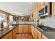 Well-appointed kitchen featuring granite countertops, custom cabinetry, and a gas cooktop at 1022 Orion Way, Castle Rock, CO 80108