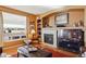 Living room featuring a fireplace, large window, and comfortable seating at 1022 Orion Way, Castle Rock, CO 80108