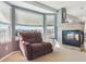 Comfortable living room featuring a tiled fireplace and a chair with a view at 1022 Orion Way, Castle Rock, CO 80108