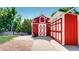 Unique red barn and garage exterior with white trim, adding character and practical space to the property at 10635 Dexter Dr, Thornton, CO 80233