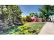 Well-maintained backyard featuring a red barn and lush lawn, creating a picturesque outdoor retreat at 10635 Dexter Dr, Thornton, CO 80233