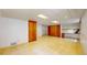 Basement area with tiled floor, offering a door, storage, and built-in desk space for flexible functionality at 10635 Dexter Dr, Thornton, CO 80233