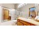 Bathroom with a shower with sliding glass doors, neutral tones and an opening view to another bathroom at 10635 Dexter Dr, Thornton, CO 80233