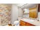 Stylish bathroom featuring floral wallpaper, modern fixtures, and a conveniently located laundry area at 10635 Dexter Dr, Thornton, CO 80233