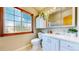 Cozy bathroom with a large window, white vanity, and decorative plants, offering a bright and airy feel at 10635 Dexter Dr, Thornton, CO 80233