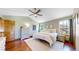 Well-lit bedroom with high ceilings, hardwood floors, two windows, and a dresser at 10635 Dexter Dr, Thornton, CO 80233
