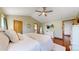 Bright, airy bedroom featuring hardwood floors, high ceilings, a tv and an opening view to the bath at 10635 Dexter Dr, Thornton, CO 80233