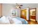 Comfortable bedroom with a window and closet and an opening view into the bathroom nearby at 10635 Dexter Dr, Thornton, CO 80233