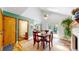Dining area with wood table, access to outdoor space, and view into kitchen at 10635 Dexter Dr, Thornton, CO 80233