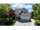 Charming two-story home featuring a well-manicured lawn, mature trees, and a welcoming facade at 10635 Dexter Dr, Thornton, CO 80233