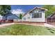 Charming backyard with a well-kept lawn and the home's exterior, creating a relaxing and private outdoor space at 10635 Dexter Dr, Thornton, CO 80233