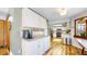 Kitchen with white cabinets, stainless steel appliances, and wood-look flooring at 10635 Dexter Dr, Thornton, CO 80233