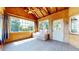 Bright and inviting sunroom with wood paneled walls, ceiling fan, and lots of windows showcasing the outdoors at 10635 Dexter Dr, Thornton, CO 80233