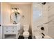 Stylish bathroom with modern vanity, round mirror, and luxurious tiled shower and tub combo at 1152 S Salida Way, Aurora, CO 80017