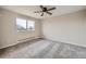 Bright bedroom with new gray carpet and large window offering plenty of natural light at 1152 S Salida Way, Aurora, CO 80017
