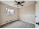 Cozy bedroom featuring plush carpet, a ceiling fan, and a bright window at 1152 S Salida Way, Aurora, CO 80017