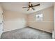 Inviting bedroom featuring plush carpet, a ceiling fan, and a bright window at 1152 S Salida Way, Aurora, CO 80017